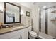 Bathroom with glass shower door and quartz vanity at 9882 S Hoyt Ct, Littleton, CO 80127
