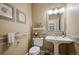 Charming powder room features neutral walls, stone tile, and a pedestal sink at 9882 S Hoyt Ct, Littleton, CO 80127