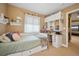 Bright bedroom with built-in storage, desk, and neutral-toned walls at 9882 S Hoyt Ct, Littleton, CO 80127