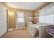 A bedroom featuring cozy decor, soft colors, and a comfortable bed at 9882 S Hoyt Ct, Littleton, CO 80127