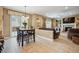 This dining area is adjacent to a living area and features sliding glass doors and hardwood floors at 9882 S Hoyt Ct, Littleton, CO 80127