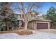 Charming two-story home features a covered porch, stone accents, and a two-car garage at 9882 S Hoyt Ct, Littleton, CO 80127