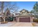 Charming two-story home features a covered porch, stone accents, and a two-car garage at 9882 S Hoyt Ct, Littleton, CO 80127