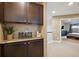 Hallway with cabinets with granite countertop and view of the bedroom at 9882 S Hoyt Ct, Littleton, CO 80127