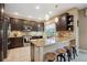 Eat-in kitchen featuring dark cabinetry, granite countertops, and stainless steel appliances at 9882 S Hoyt Ct, Littleton, CO 80127