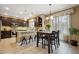 Eat-in kitchen featuring dark cabinetry, granite countertops, and stainless steel appliances at 9882 S Hoyt Ct, Littleton, CO 80127