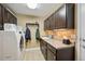 Practical laundry room features modern appliances, ample counter space, and overhead lighting at 9882 S Hoyt Ct, Littleton, CO 80127