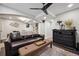 Basement living room with a leather sofa, ceiling fan, and modern fixtures at 9882 S Hoyt Ct, Littleton, CO 80127