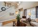 Open living room area featuring vaulted ceilings, hardwood floors, and a staircase at 9882 S Hoyt Ct, Littleton, CO 80127
