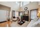 Bright living room featuring vaulted ceilings, large windows, and neutral decor at 9882 S Hoyt Ct, Littleton, CO 80127
