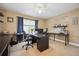 A well-lit office featuring a ceiling fan, lots of workspace, and an inspiring message on the wall at 9882 S Hoyt Ct, Littleton, CO 80127