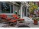 Inviting patio offers comfortable seating area with plush cushions and a view of the home's exterior at 9882 S Hoyt Ct, Littleton, CO 80127