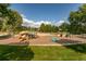 Attractive community playground featuring slides, climbing structures, and a playful dinosaur statue at 9882 S Hoyt Ct, Littleton, CO 80127