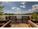 Picturesque wooden deck overlooking a pond with blue skies and a natural setting at 9882 S Hoyt Ct, Littleton, CO 80127