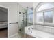 Bright bathroom featuring a soaking tub with large window and a glass-enclosed shower with sleek, modern fixtures at 10053 Granite Hill Dr, Parker, CO 80134