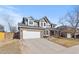 Traditional two-story house with brick accents, attached garage, and large driveway at 10053 Granite Hill Dr, Parker, CO 80134