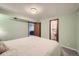 Cozy bedroom featuring beadboard walls and ceilings with doorways to living room and bathroom at 11627 E Virginia Pl, Aurora, CO 80012