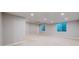 Bright basement area with two windows, neutral decor, and ceiling fan, offering a versatile living space at 3565 New Haven Cir, Castle Rock, CO 80109