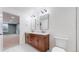 Bathroom features a wood vanity with double sinks, modern fixtures and white tile flooring at 3565 New Haven Cir, Castle Rock, CO 80109