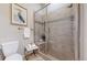 Bathroom featuring glass shower with tile, bench, and a wall-mounted towel rack with decorative art at 3565 New Haven Cir, Castle Rock, CO 80109