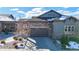 Charming home featuring a stone and siding exterior, complemented by a two-car garage and well-maintained landscaping at 3565 New Haven Cir, Castle Rock, CO 80109
