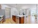 Modern kitchen island with stainless steel dishwasher, sink, and hardwood flooring at 3565 New Haven Cir, Castle Rock, CO 80109