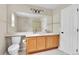 Bathroom features a double vanity, toilet and large mirror at 22974 E Dorado Dr, Aurora, CO 80015