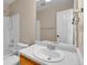 Bathroom features a white sink, tile wall, and vanity, with an open door to an adjoining room at 22974 E Dorado Dr, Aurora, CO 80015