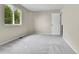 This bedroom has neutral walls and carpet, plus a large window offering natural light at 22974 E Dorado Dr, Aurora, CO 80015