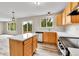 Modern kitchen with stainless steel appliances, wood cabinets, and ample counter space and a breakfast bar at 22974 E Dorado Dr, Aurora, CO 80015