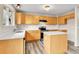 Well-lit kitchen featuring stainless steel appliances, ample counter space, wood cabinets, and modern lighting at 22974 E Dorado Dr, Aurora, CO 80015