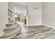 Cozy living room featuring staircase, wood floors, and views into the adjacent dining area and kitchen at 22974 E Dorado Dr, Aurora, CO 80015