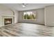 Bright living room features a fireplace, large window, wood floors and a ceiling fan at 22974 E Dorado Dr, Aurora, CO 80015