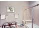 Bathroom features frameless shower, tiled walls, bench, and two decorative ottomans at 15855 Wild Horse Dr, Broomfield, CO 80023