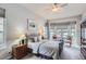 Cozy bedroom featuring neutral tones, a ceiling fan, and large windows for natural light at 15855 Wild Horse Dr, Broomfield, CO 80023