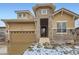 Inviting home featuring a stone tower entrance, well-kept landscaping, and a two-car garage at 15855 Wild Horse Dr, Broomfield, CO 80023