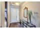 Welcoming foyer featuring hardwood floors, console table, decor, and natural light at 15855 Wild Horse Dr, Broomfield, CO 80023