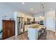 The updated kitchen features an island, stainless steel appliances and modern lighting at 15855 Wild Horse Dr, Broomfield, CO 80023