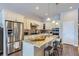 Bright kitchen features an island with granite countertops, stainless steel appliances and pendant lighting at 15855 Wild Horse Dr, Broomfield, CO 80023