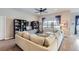 Spacious living room with hardwood floors, bookshelves, and a large window with natural light at 15855 Wild Horse Dr, Broomfield, CO 80023