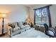 Bright living room with large window, neutral sofa, and ottomans at 15855 Wild Horse Dr, Broomfield, CO 80023