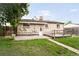 Backyard with a brick house and a small wooden deck at 7839 Florado St, Denver, CO 80221