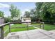 Lush backyard featuring a shed, wooden deck, and mature trees, perfect for outdoor living at 7839 Florado St, Denver, CO 80221