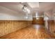 Spacious basement with paneled walls, wood-look flooring, and ample lighting at 7839 Florado St, Denver, CO 80221