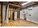 Unfinished basement with exposed ceiling and essential utility equipment at 7839 Florado St, Denver, CO 80221