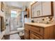 Bathroom featuring a marble tiled walk-in shower and a wood vanity with granite countertop at 7839 Florado St, Denver, CO 80221