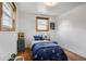 Cozy bedroom with hardwood floors and natural light from two windows at 7839 Florado St, Denver, CO 80221