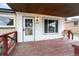 Inviting front porch with a covered entry, decorative door, and a chair for relaxing at 7839 Florado St, Denver, CO 80221
