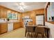 Kitchen with ample wood cabinets, appliances, an eat-in area, and lots of natural light at 7839 Florado St, Denver, CO 80221