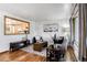 Inviting living room with hardwood floors, stylish furniture, and natural light from large windows at 7839 Florado St, Denver, CO 80221